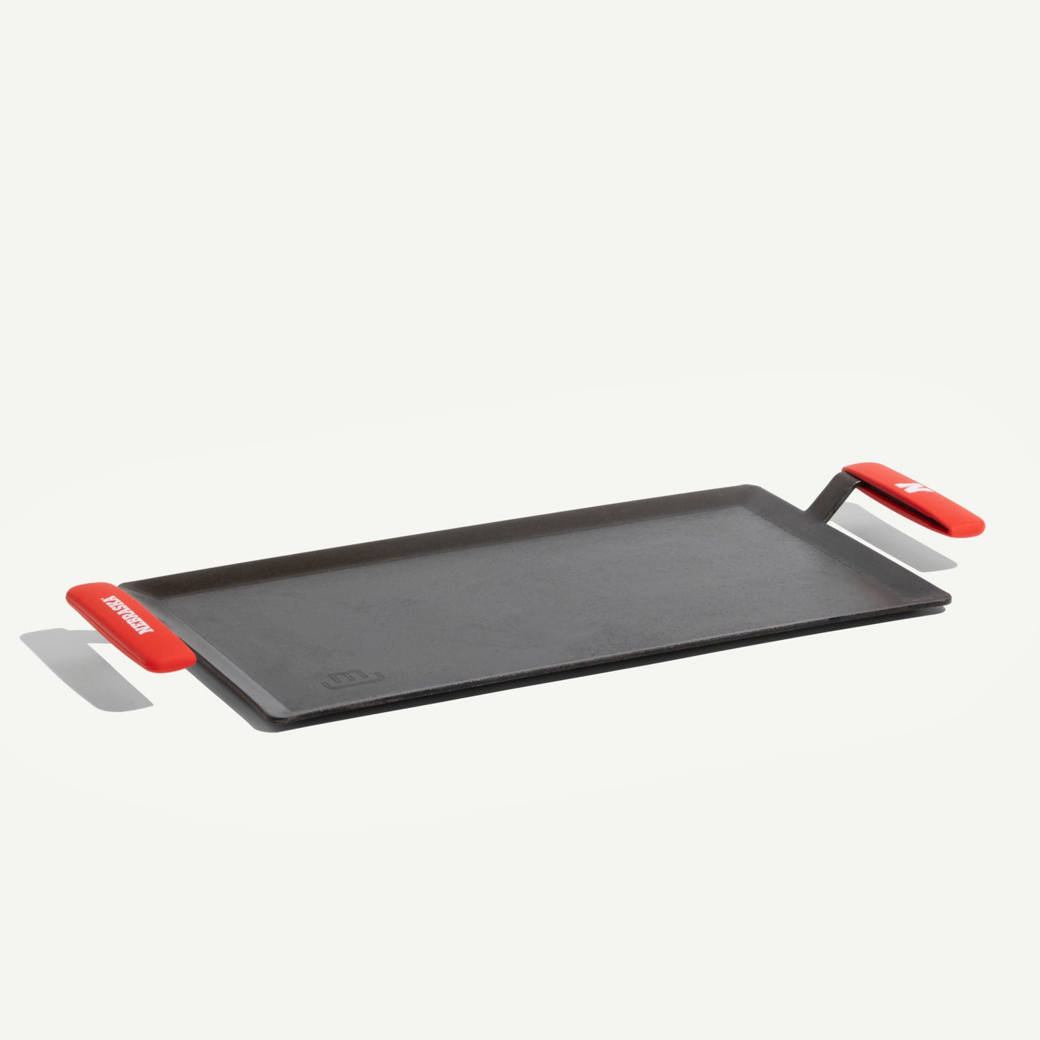 made-in-carbon-steel-griddle-with-university-of-nebraska-cornhuskers-silicone-ha image 1